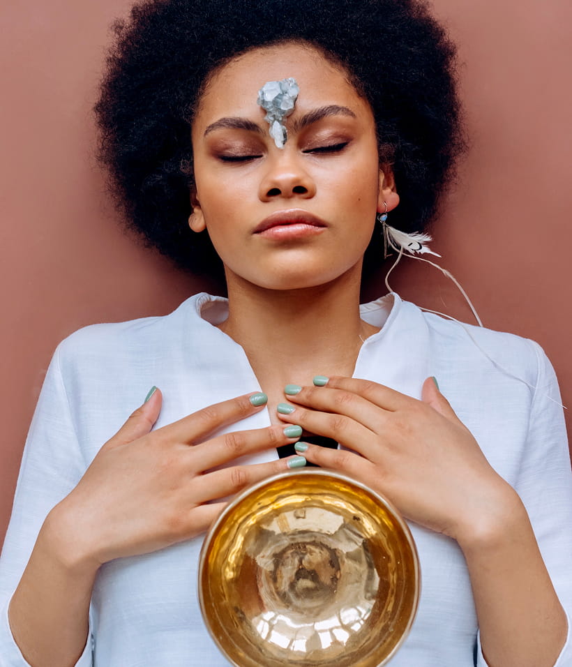 lady laying down with stones